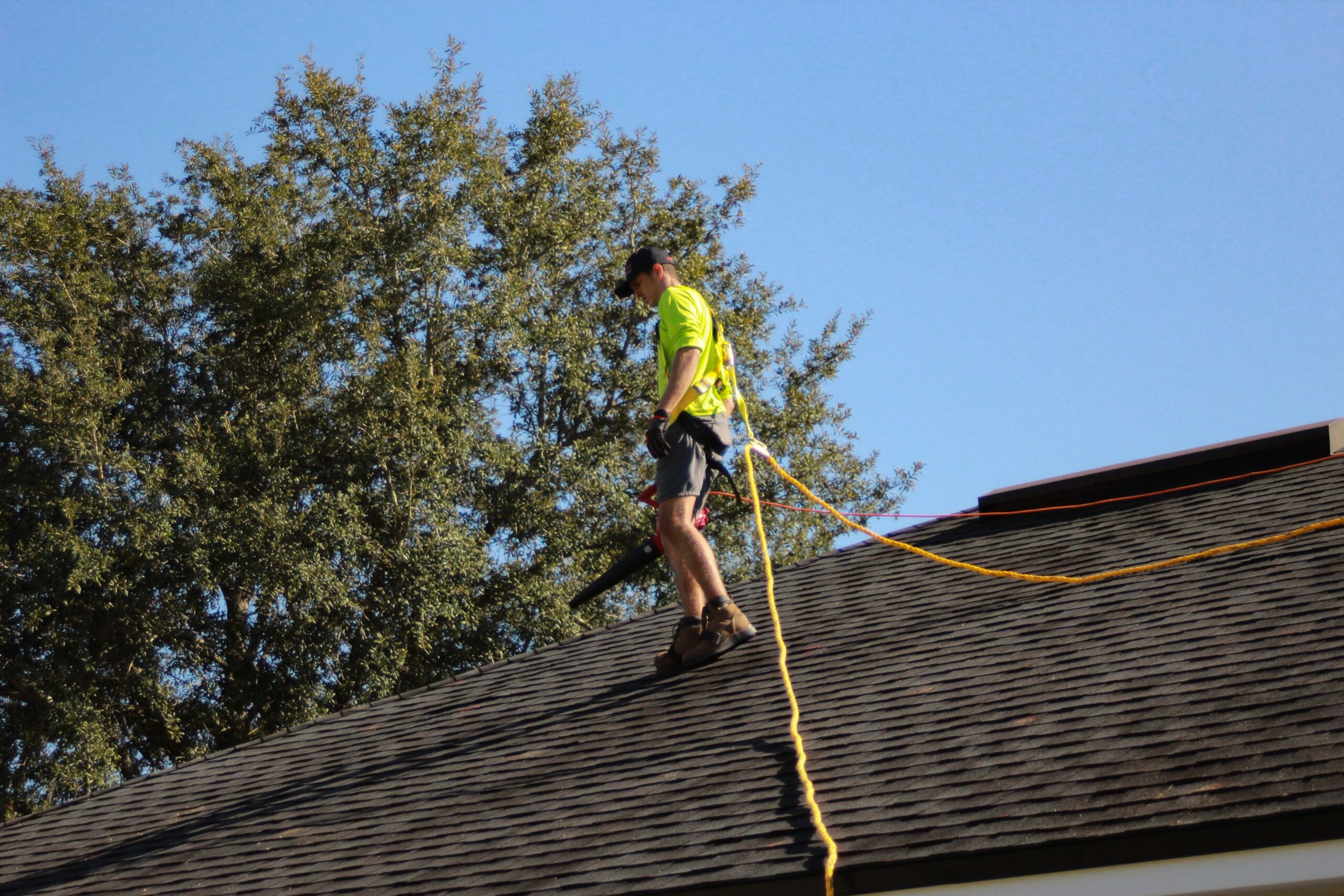 A contractor surveys a new roof after installing architectural shingles